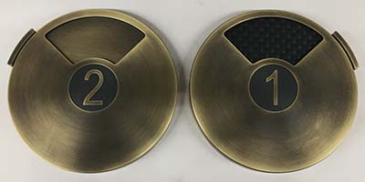 Custom door occupancy hardware milled from solid brass with a dark antiquie metal finish.